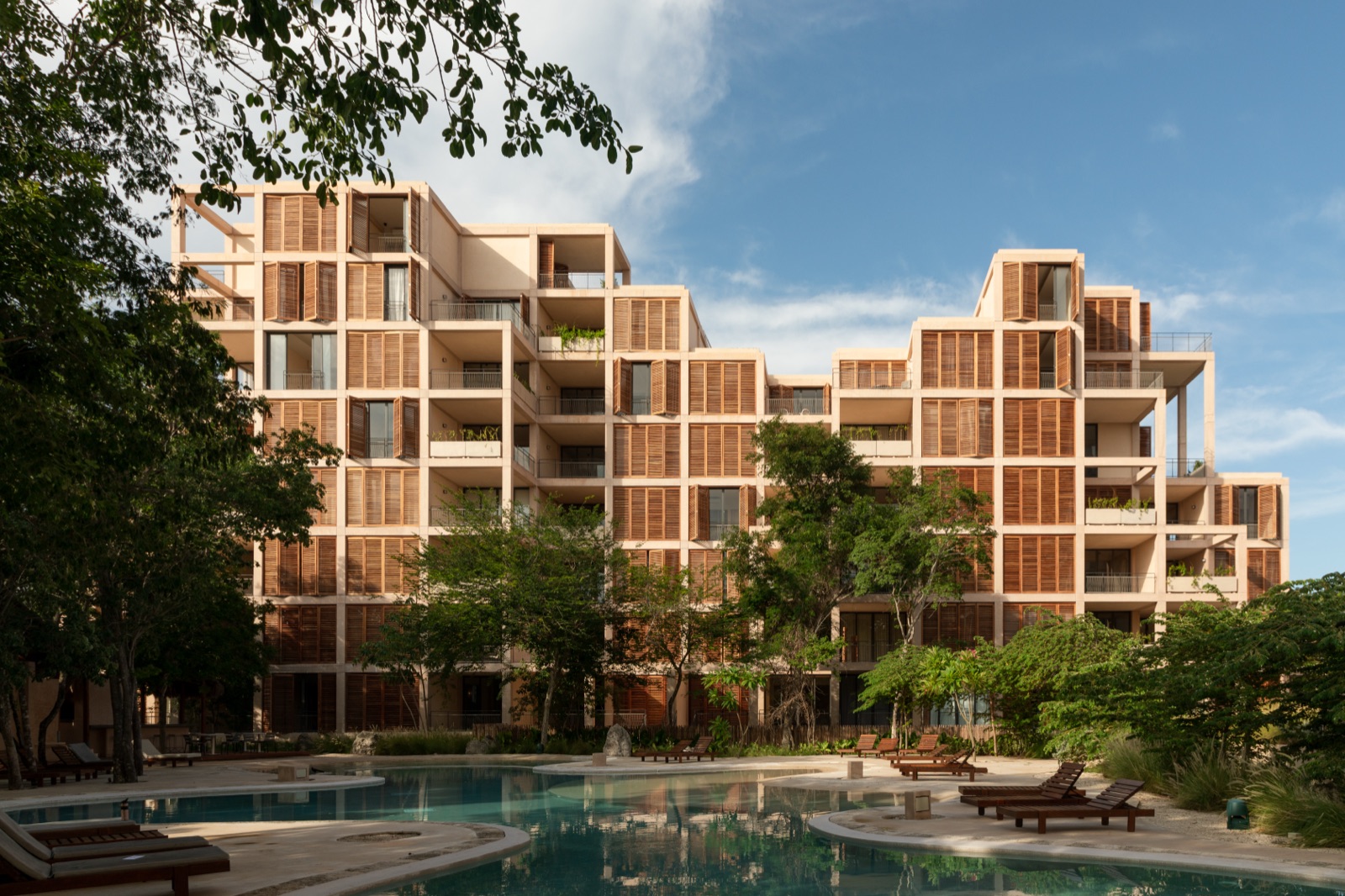 The Village's cubic Sordo Madaleno towers above the family pool (verified, 6720x4480)